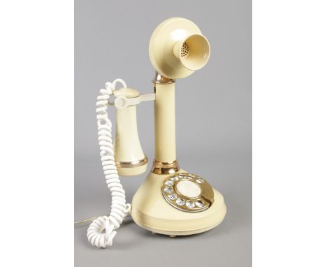 A cream Deco-Tel candlestick telephone, model no. AAI 4102.  