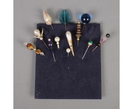 A quantity of vintage hat pins including simulated pearl and gemstone examples.  