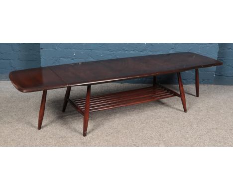 An Ercol dark elm extending coffee table, with rectangular top and drop down leaves to each side. Height: 37cm, Width: 104/16