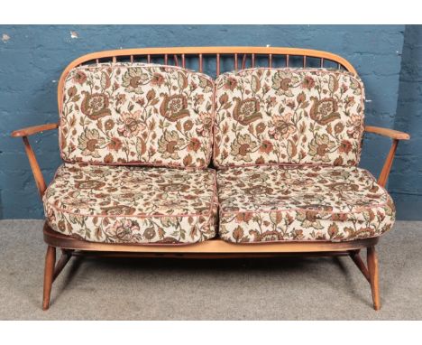 An Ercol two seat sofa.