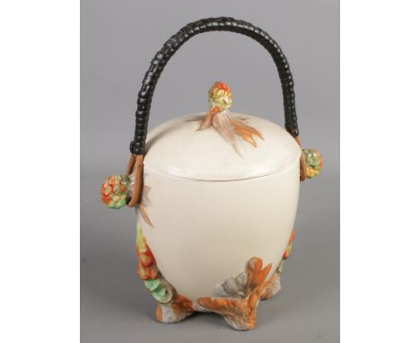 A Newport Pottery Clarice Cliff lidded barrel. With swing handle. (20cm)  Chip to lid.