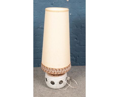 A stone ware lamp featuring tall shade.  