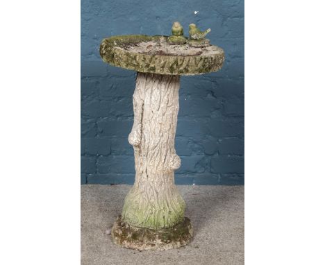 A concrete bird bath formed as a tree trunk. Height 72cm.  