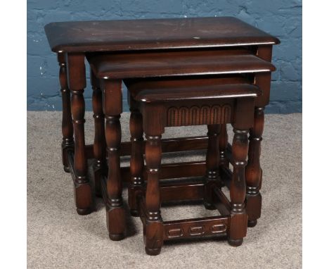 An Ercol style dark nest of three tables.  