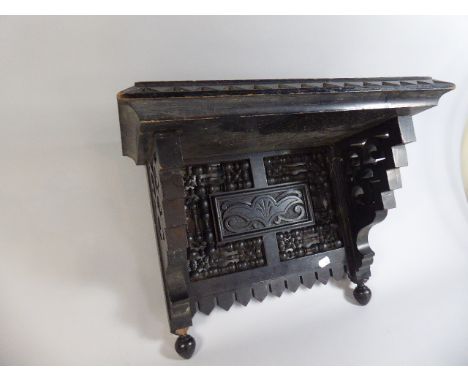 An Aesthetic Movement Rectangular Wall Shelf Bracket with Carved and Turned Decoration, 46cm Wide and 36cm high 