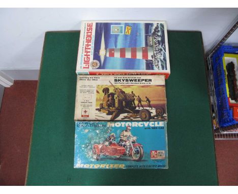 Three Boxed Vintage Plastic Model Kits comprising of The Lindberg Line Battery Operated Lighthouse, Renwal 75mm Anti-Aircraft