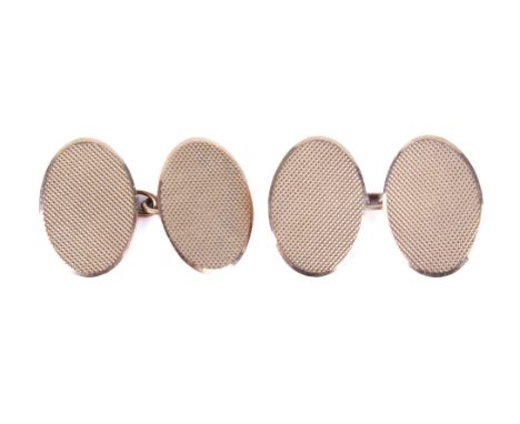 A pair of 9ct gold cufflinks. Of oval form with crosshatched decoration, hallmarked, gross weight 6.2g.