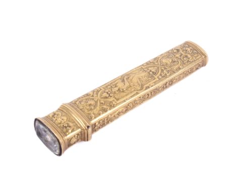 A yellow metal wax case and seal. Of tapered rectangular form, heavily decorated with scenes of figures surrounded by scrolls