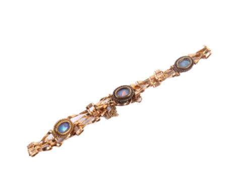A rose coloured metal bracelet. Tests at least 9ct, having triple cut opal details between links, 3.8g gross