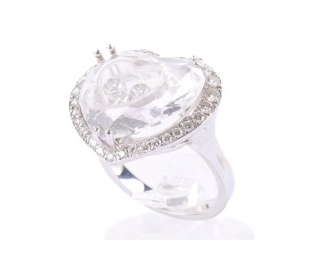 A Chopard signed 'Happy Diamonds' 18ct white gold ring. The heart containing three loose stones, encircled with a diamond bor