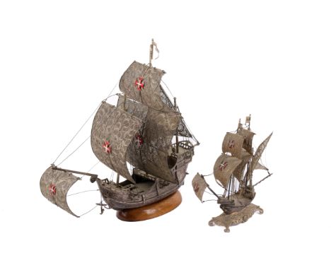 Two white metal filigree sailing boats ornaments. Both having intricate sails featuring red and white enamel crosses, one mou