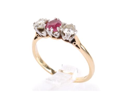 An 18ct gold diamond and ruby dress ring. Stamped 18ct and PLAT and tests at least 18ct. Size L, weight, 2.3g