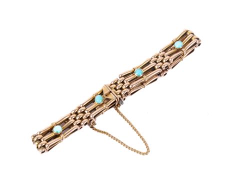 A 15ct gold and blue stone bracelet. The gate links set with a small turquoise cabochon, stamped 15 to the clasp, andtested a