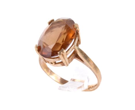 A 9ct gold stone ring. Set with an oval cut golden beryl of 4.50 carats estimated weight in a high profile setting. Size M. W