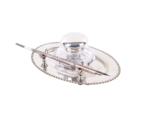 A silver lidded inkwell with a silver pen and silverplated dish. The pen hallmarked Chester 1919, (makers mark rubbed), L17cm