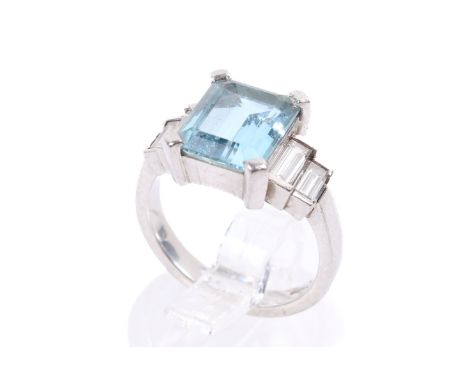 A platinum, aquamarine and diamond ring by Nicholas Wylde. The emerald cut aquamarine measuring circa 9mm x 7mm, weighing cir