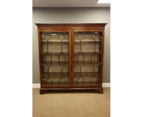 Large Georgian mahogany free standing bookcase, projecting cornice with dentil detail, two astragal glazed doors, eight adjus