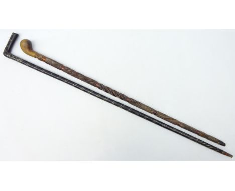 Hardwood walking stick, pique worked with spiral and diamond decoration and another with carved detail, L92cm max (2)