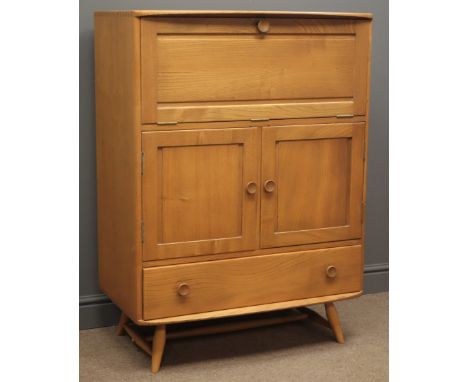 Mid 20th century Ercol elm and beech serving cabinet, fall front enclosing shelf compartments, two door cupboard with an adju