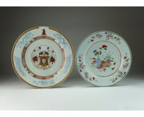 A Chinese Imari armorial dish, Qianlong, the centre crest framed by a flower and scroll panel verge border, the rim with drag