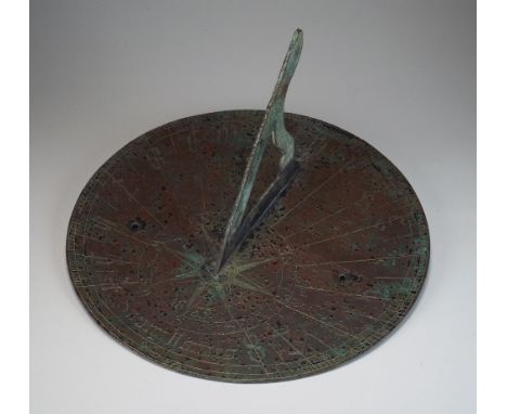 An early 20th century patinated sundial in 17th century style bears date 1665, 25cm diameter