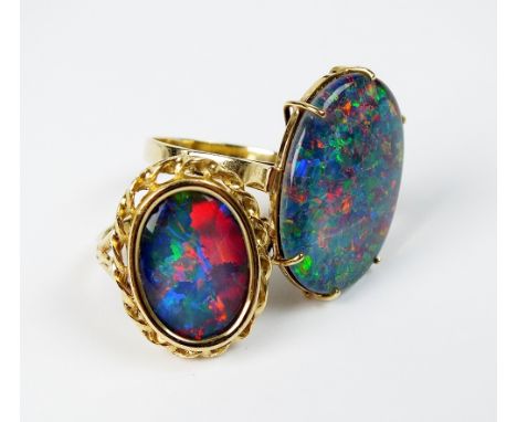 An oval opal triplet dress ring, the decorative pierced yellow metal shank stamped '375', together with a further opal triple