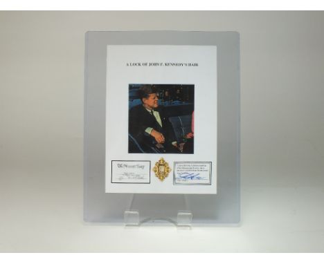 A piece of John F. Kennedy's Hair, as certified by Louis Mushro from the Manuscript society, contained within small gilt fram