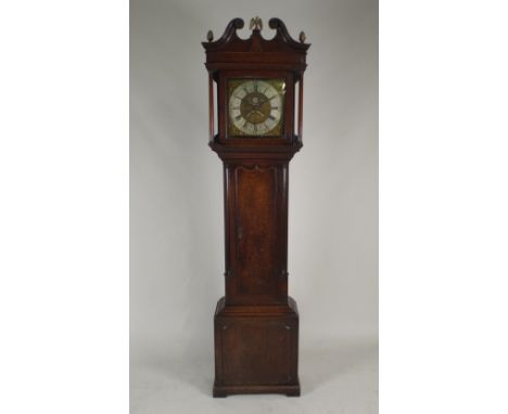 An 18th century oak thirty hour longcase clock, the 12 inch square brass dial with centred twin apertures, the silvered chapt