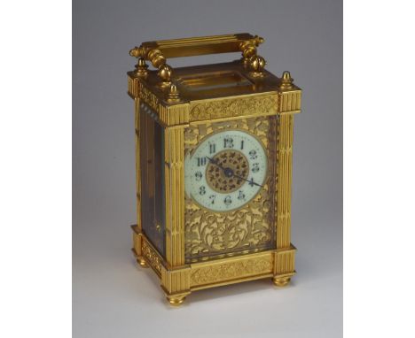 A late 19th/early 20th century Brass Carriage timepiece the dial with 2 inch ring of Arabic numerals with scrolling leaves an