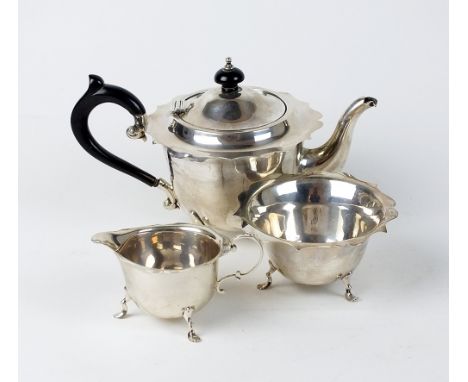 A three piece bachelors silver tea service, Barker Brothers, Chester 1920, 1923 & 1924, each piece of circular form with cusp