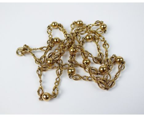 A yellow metal decorative chain and bead necklace, the bolt ring stamped '9ct', weight 26.7gms