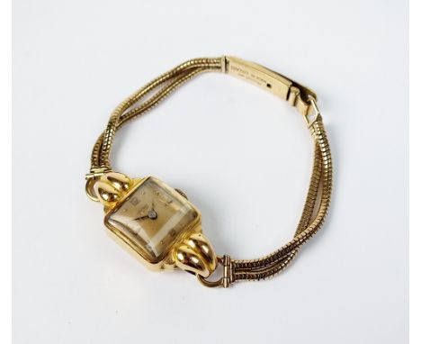 A lady's 18ct gold Aerowatch Neuchatel cocktail watch, the cushion shaped champagne dial with Arabic numerals and batons, man
