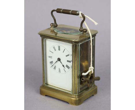 A brass-cased carriage clock having black roman numerals to the white enamel dial, 10.5cm high. 