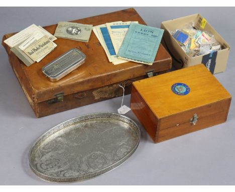 A tan suitcase, 50cm wide; together with a Lion “Manucator”; a cut-throat razor; an engraved silver-plated oval tea tray, etc