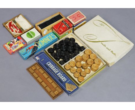 A miniature set of travelling chessmen, cased; a cribbage board; two sets of dominoes; a set of draughtsmen; &amp; eight pack