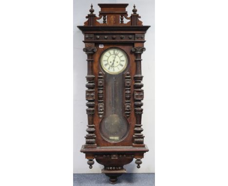A late 19th century Vienna-style large wall clock with black roman numerals to the two-part white enamel dial, having a strik