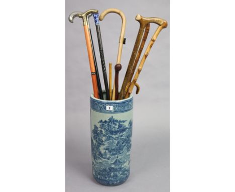 Ten various walking canes, riding crops, &amp; umbrellas; together with a Chinese-style blue &amp; white decorated cylindrica
