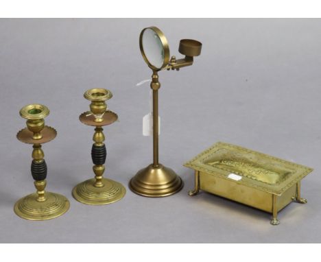 A Victorian-style brass adjustable table-standing magnifying glass; a pair of brass &amp; carved treen candlesticks, 20cm hig