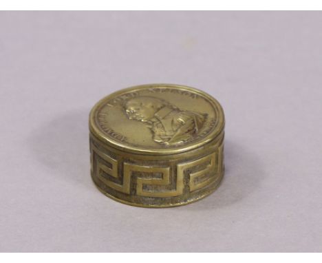 An early 19th century brass snuff box commemorating Admiral Lord Nelson, with titled portrait to the circular lid, the base i