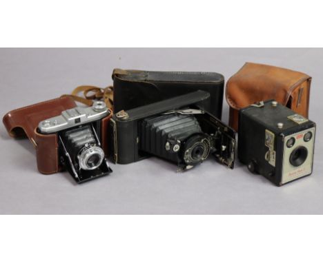 A Kodak folding camera; two other cameras; &amp; a Minolta 70mm camera lens. 