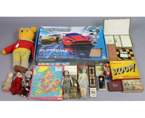 A Scalextric “Aston Martin” supreme velocity racing car set, boxed; a Rupert the bear soft toy; various costume dolls, etc.