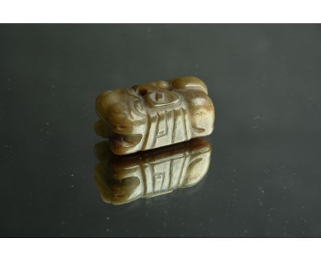 Chinese greenish brown and russet jade carving of a recumbent tiger, Ming/Qing Dynasty, 5cm long. 