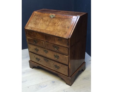 C18th walnut crossbanded bureau with fitted interior and well drawer over 2 s and two long moulded edge drawers on bracket fe