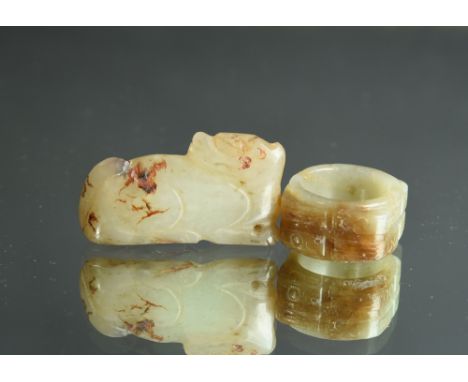 Chinese celadon and russet jade archer’s ring; together with a pale celadon jade carving of a mythical beast, 4.5cm long; Min