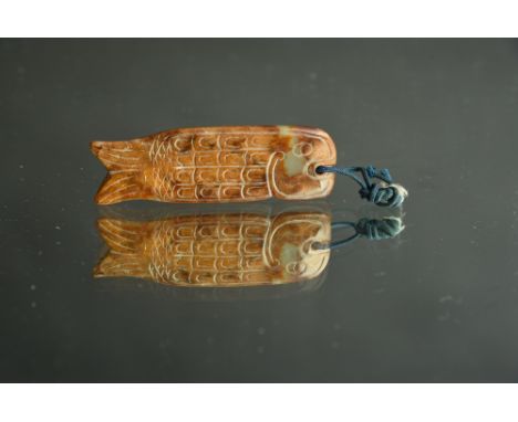 Chinese yellow and russet jade carving of a fish, Zhou Dynasty, 7cm long. 
