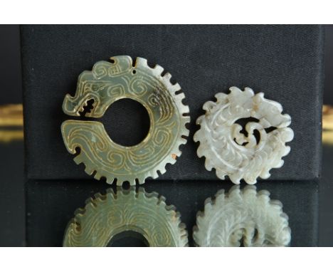 Two Chinese jade ritual notched ‘dragon’ discs, the first stone of green and russet colour, 5.5cm diam; the second of greyish