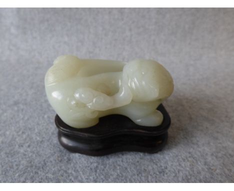 Chinese white jade waterpot in the form of a lion on carved wooden stand, 6cmL