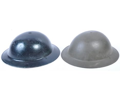 Two post-WWII Second World War British Army steel Brodie type helmets. One having a metallic green repaint with a relic condi