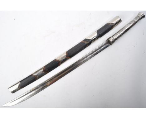 An early 20th Century South East Asian / Burmese Dha sword / knife. The sword having a smooth rounded pommel and a white meta