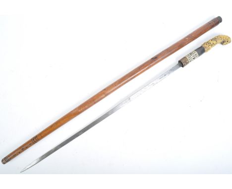 A 19th Century Victorian gentleman's sword stick / walking cane with concealed blade. The cane having an intricately carved b